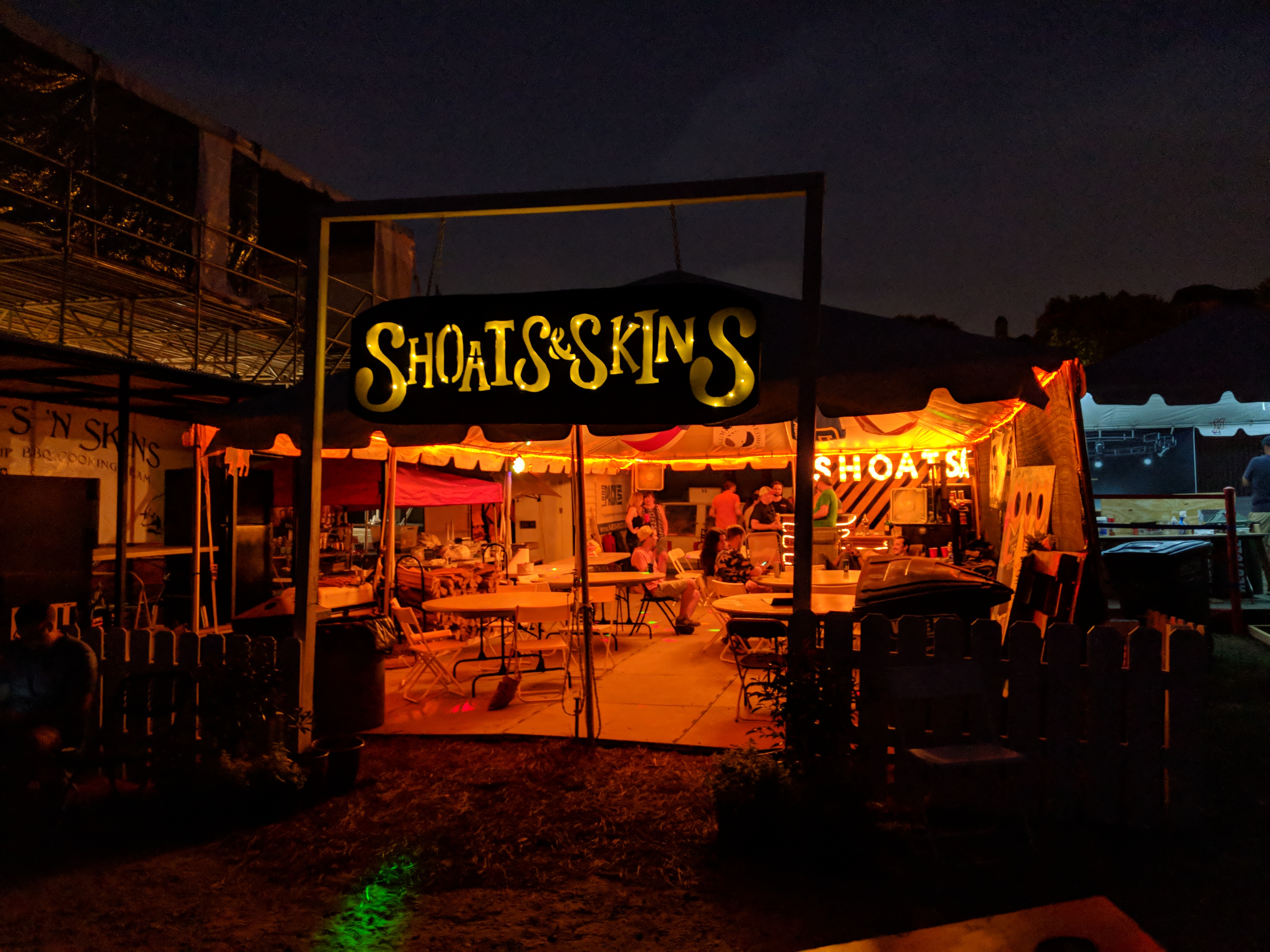 Sign and tent at night